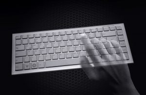 Hacking concept - Transparent hands over computer keyboard